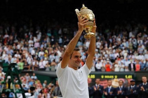 El suizo Roger Federer levanta, ayer, su octavo trofeo conquistado en Wimbledon.
